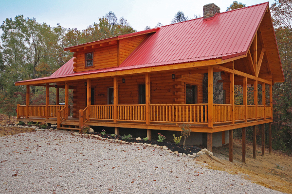 red roof cabin with wrap around porch